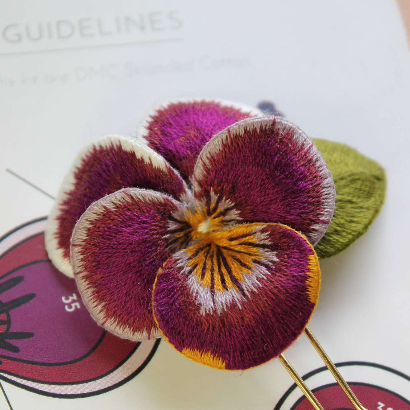 Hand embroidered Viola Hairpin with Silk Shading embroidery transitioning from yellow to purple, stitched by Pippa Haynes.