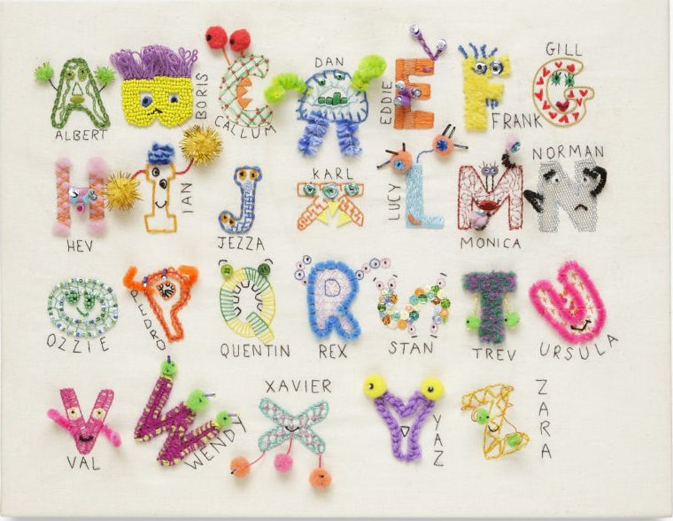 A square white canvas print featuring colorful embroidered letters of the alphabet, each styled as a unique character with names printed underneath, shown against a plain white background.